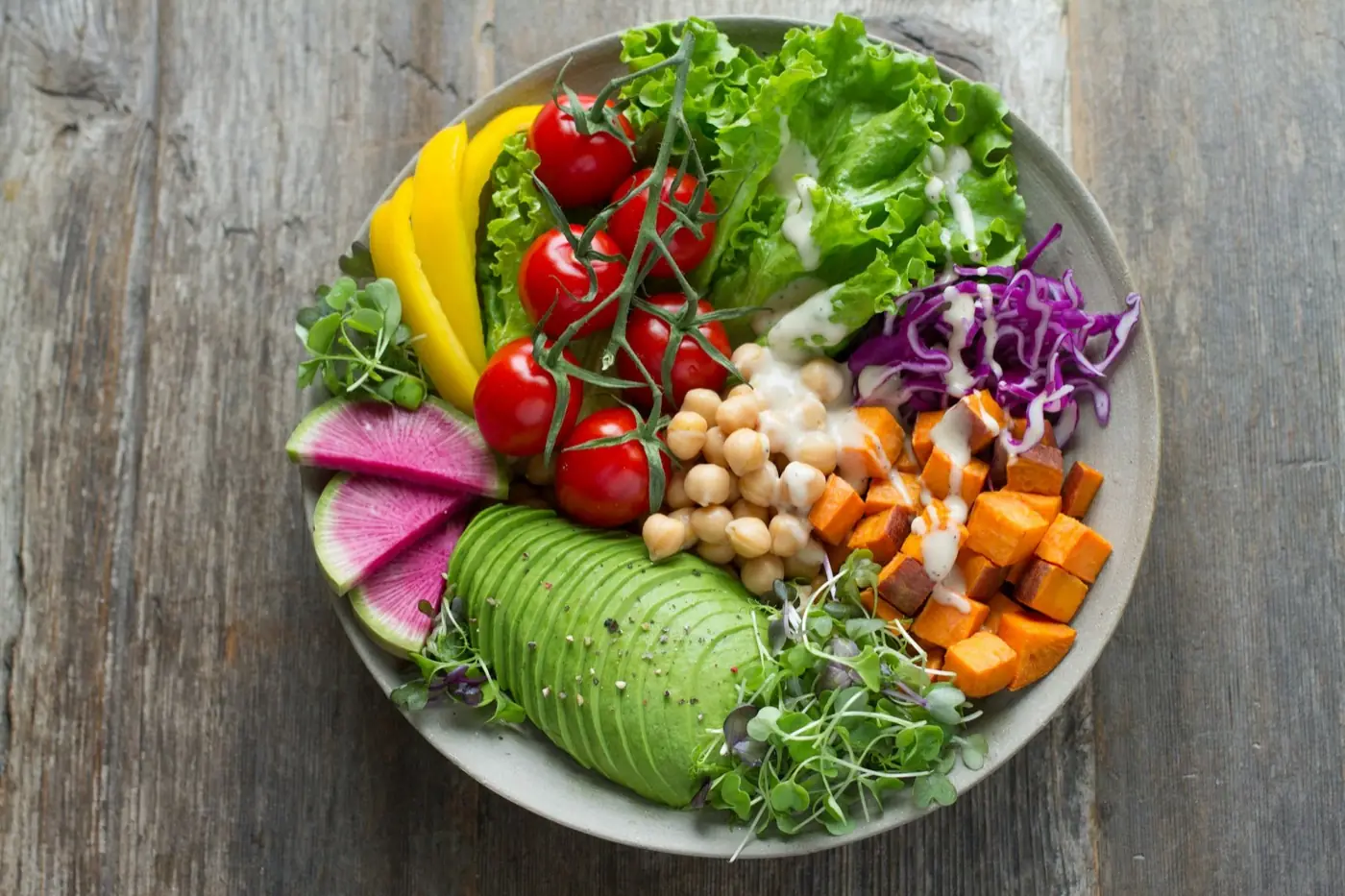 A colourful plate of fresh vegetables, chickpeas and avocado